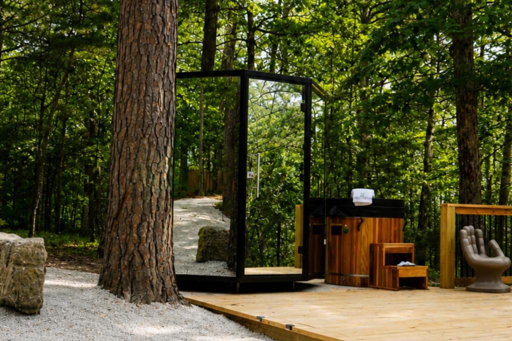 a wooden deck with a mirror next to a tree at Forest Springs Resort in Eureka Springs