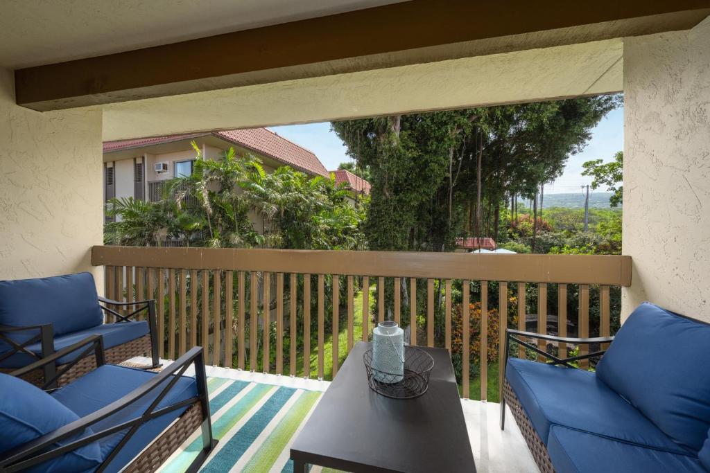 a patio with two chairs and a table on a balcony at Kona Mansions#226 in Kailua-Kona
