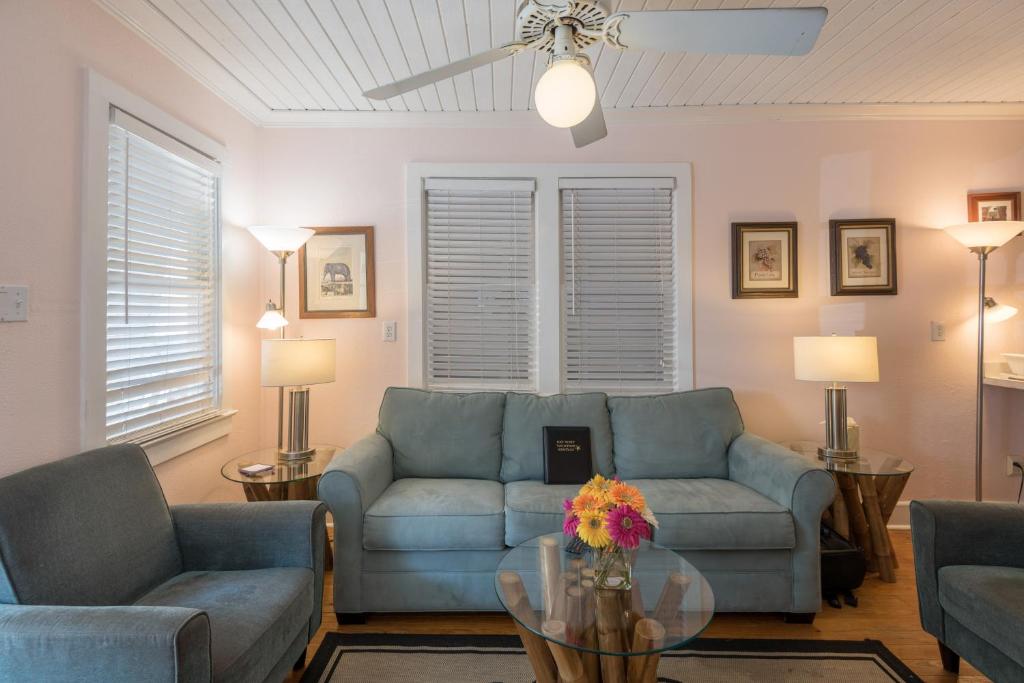 a living room with a couch and chairs and a table at KW41 Amelia House in Key West