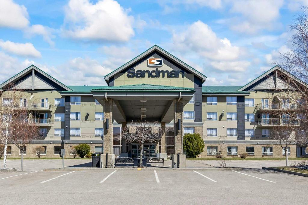 a parking lot in front of a building at Sandman Hotel & Suites Calgary West in Calgary