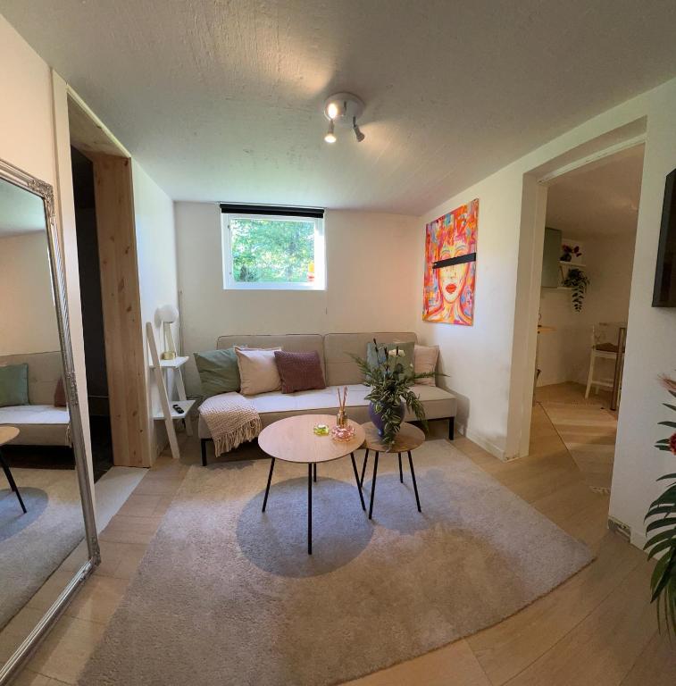 a living room with a couch and a table at Mysig Lägenhet in Varberg