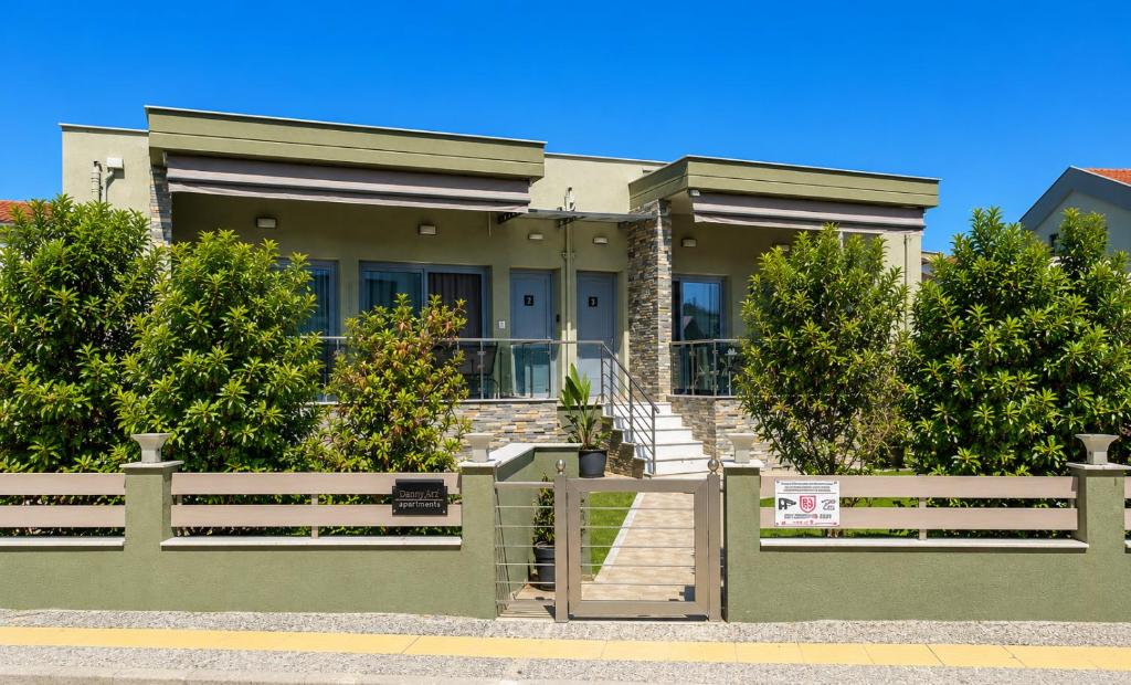 a house with a fence in front of it at Danny Arz Apartments in Iraklitsa