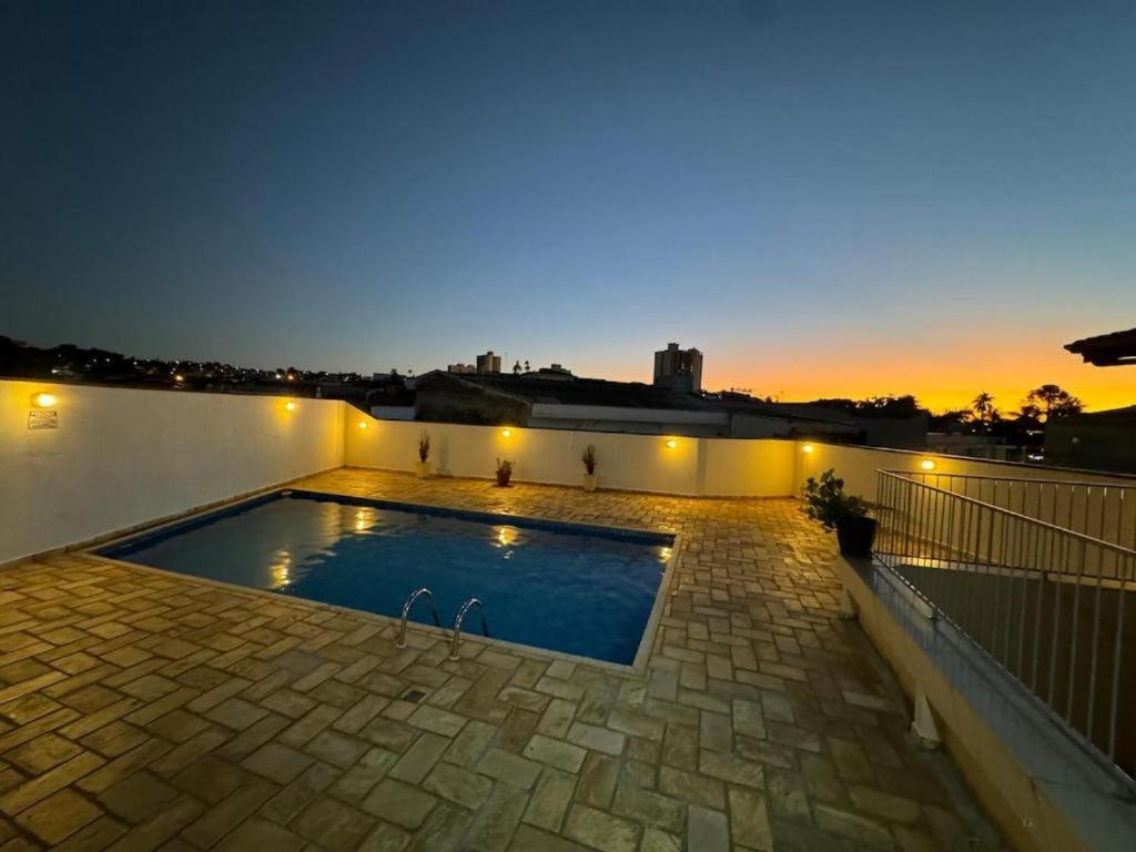a swimming pool on the roof of a building at night at Casa Villa Coloniale in Espirito Santo Do Pinhal