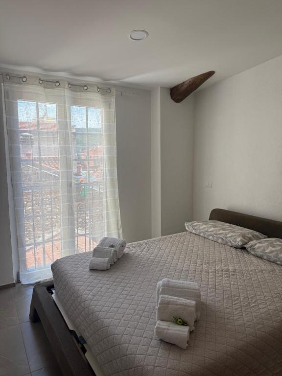 a bedroom with a bed with towels on it at Chiara 5 in Cairo Montenotte