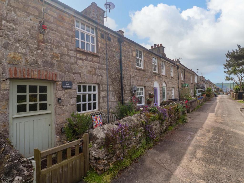 a row of brick houses on a street at May Cottage in Pentewan