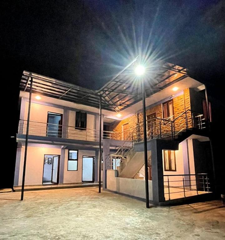 a building with a light on top of it at night at La Murphy Homestay in Cherrapunji