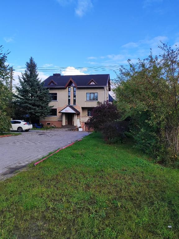 a large house with a car parked in the driveway at SunKiss in Melnragė