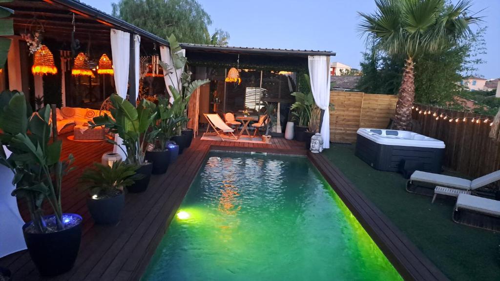 a swimming pool in a backyard with a house at chambres d hôtes villa del sole in Puget-sur-Argens