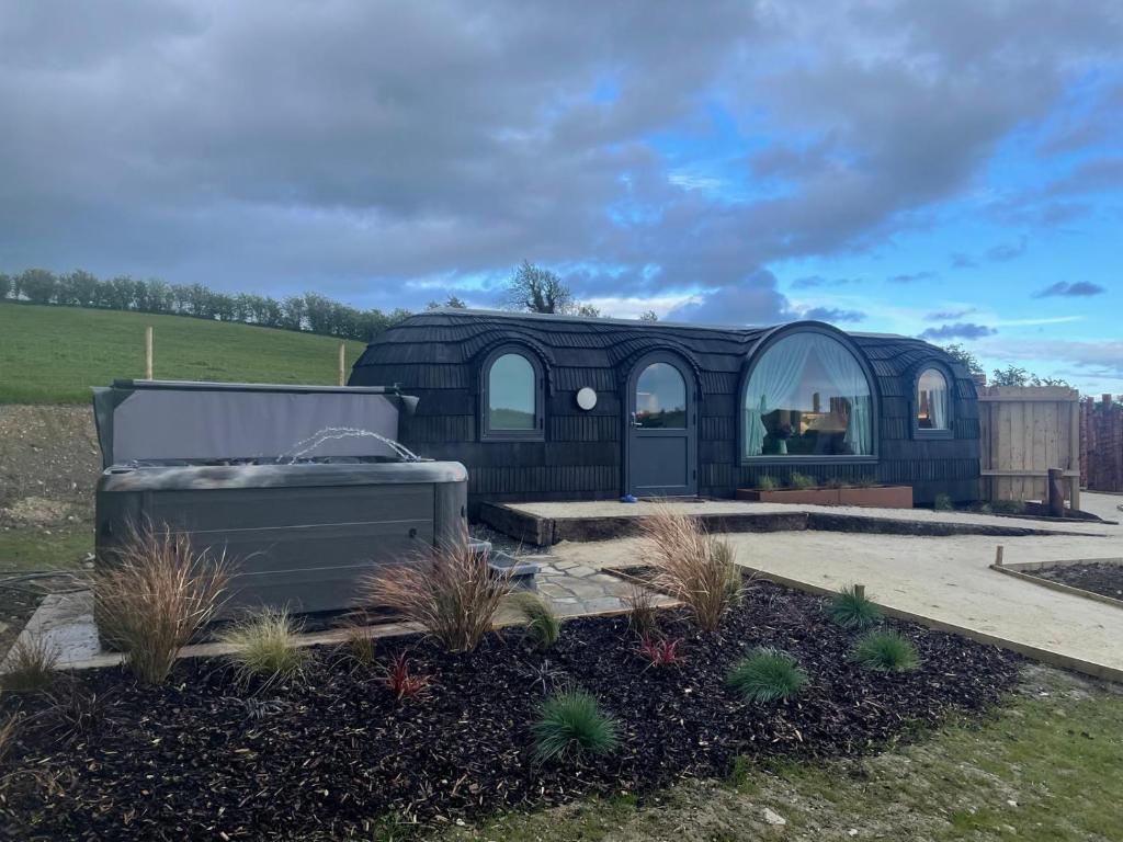 a black building with a window in a yard at The Hare's Lair in Monaghan