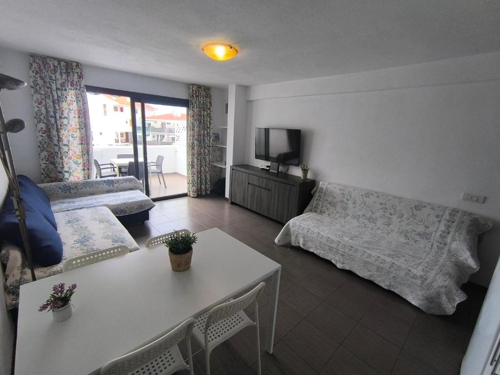 a living room with a couch and a table at Apartment Parque Royal Costa Adeje in Adeje