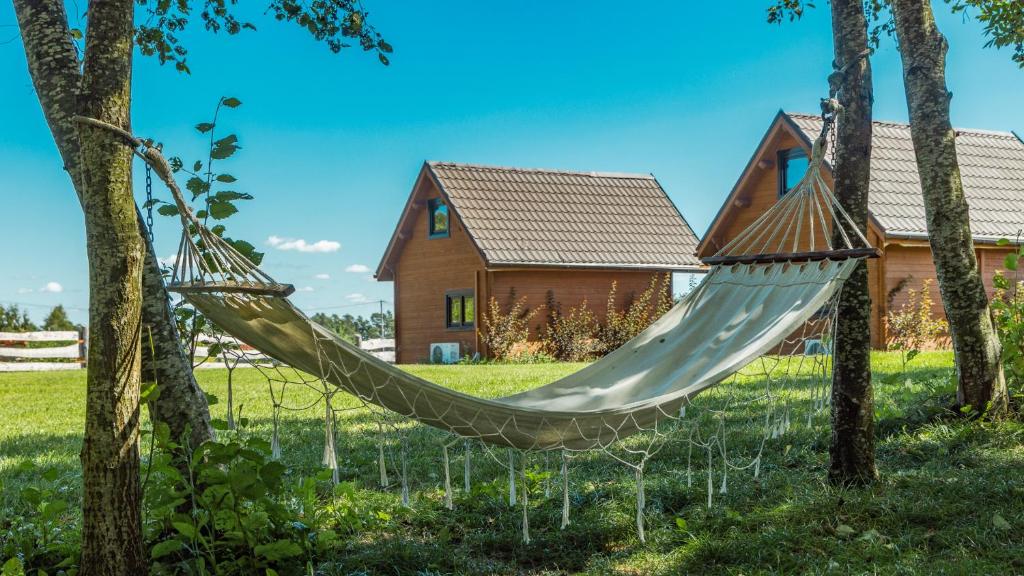 a hammock in front of a house at "OhMazury" ogród i winnica in Giżycko