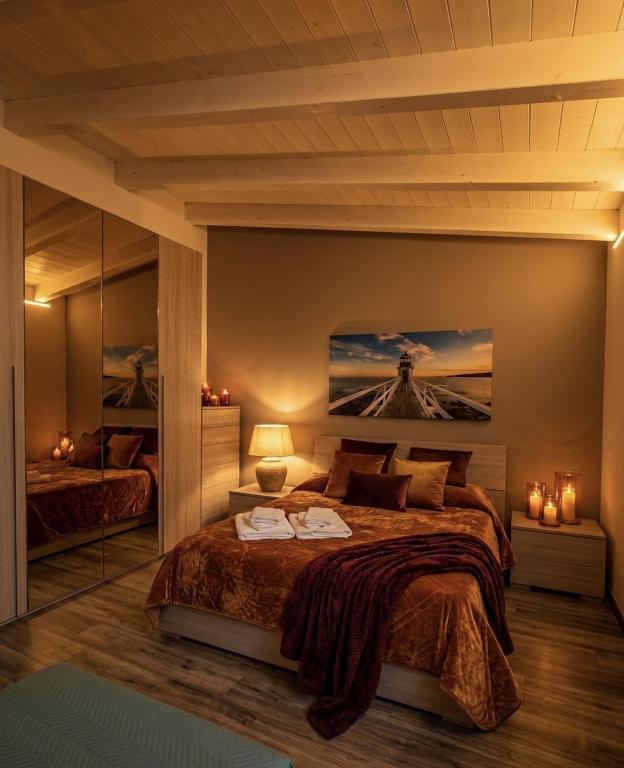 a bedroom with a large bed with a painting on the wall at Alle Volte Maison in Grumo Appula
