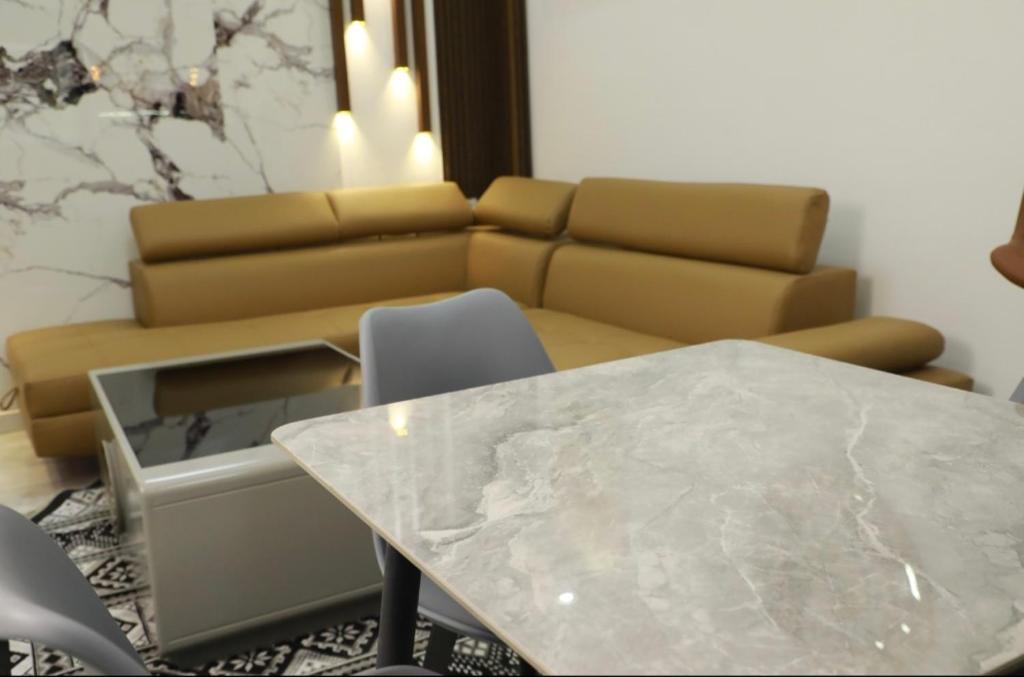 a living room with a table and a couch at Belgaid résidence OREVA in Oran