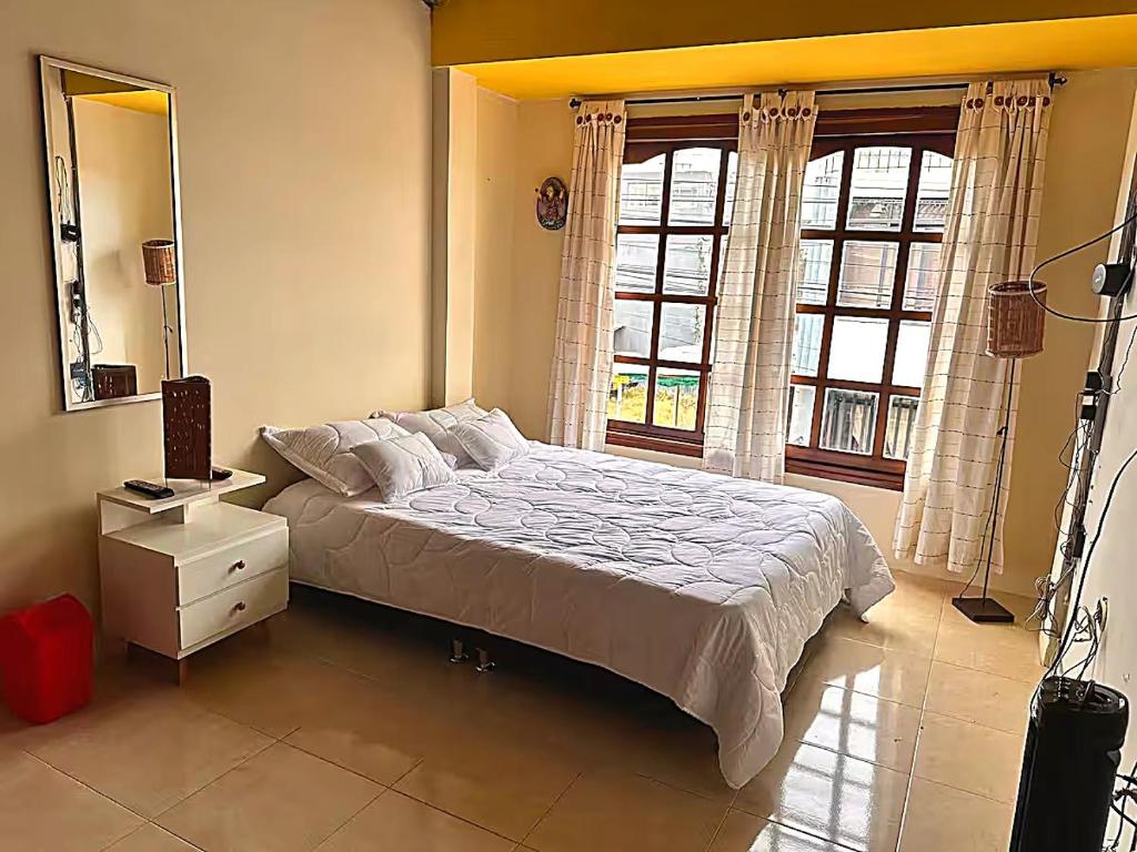 a bedroom with a large bed and a window at Quimbaya Private House in Quimbaya