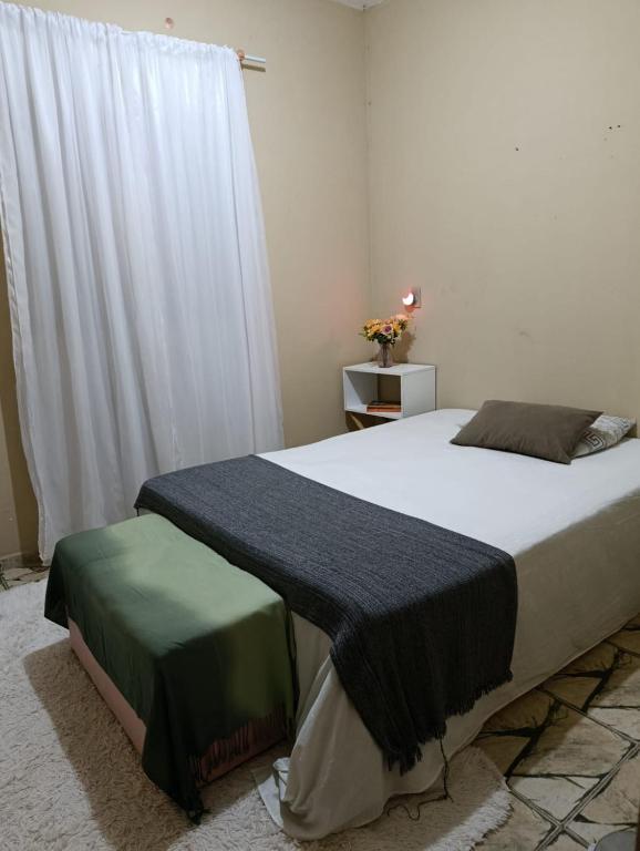 a bedroom with a bed with a blanket on it at SPA Alexandre Maia quarto 2 in Juazeiro do Norte