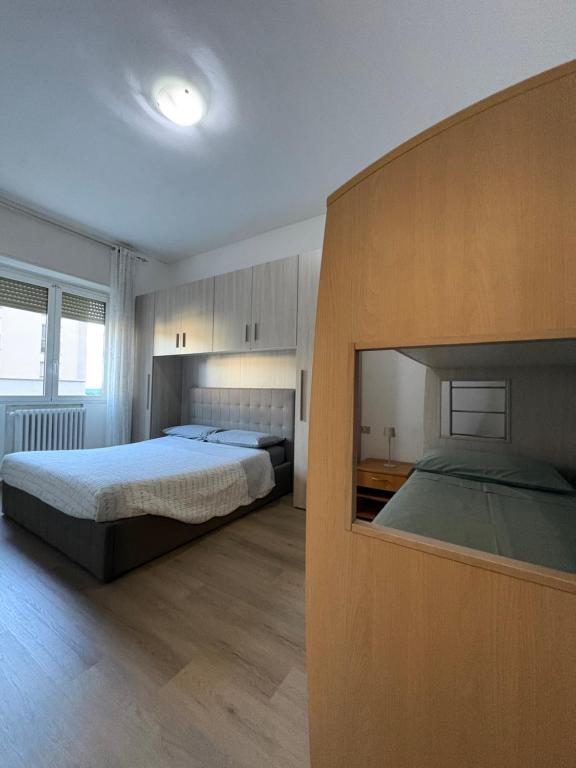 a bedroom with two beds and a large window at Casa del Pepo in Segrate