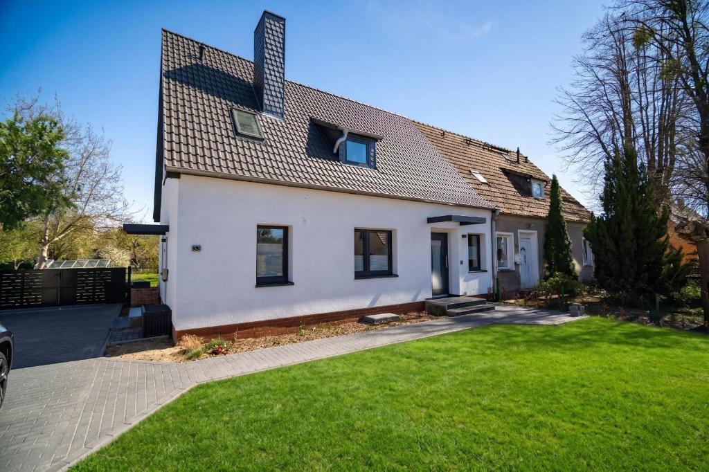 a white house with a roof at Ferienwohung-Liv-OG in Rechlin