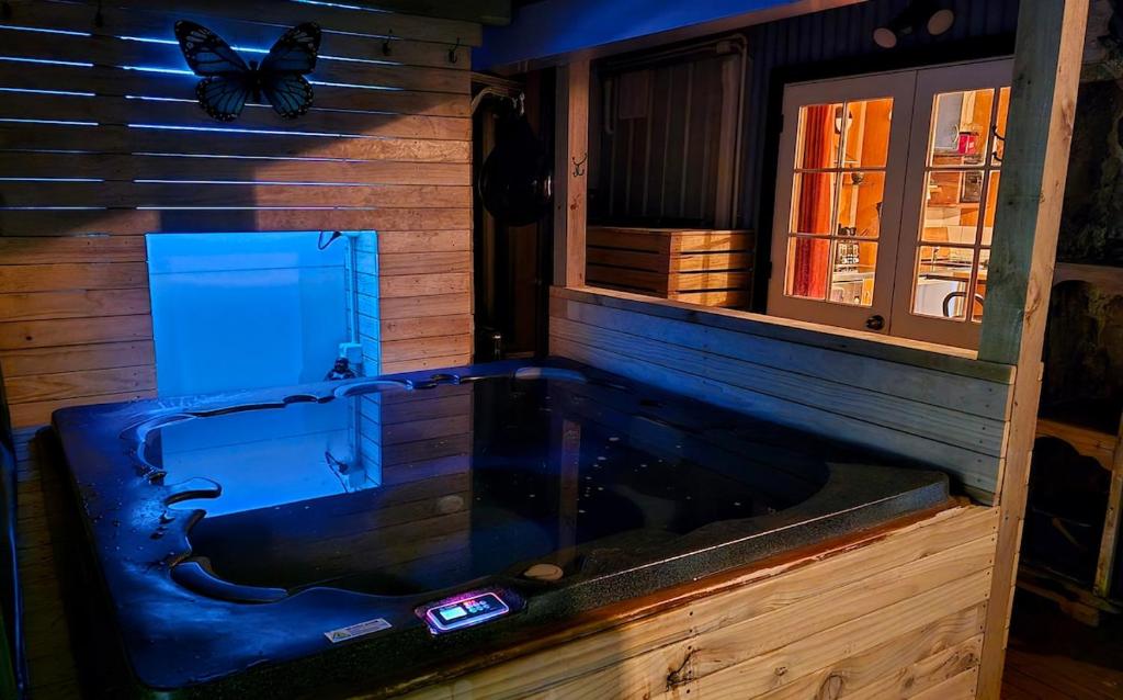 a bath tub in a room with a butterfly on the wall at Algo Azul Something Blue in Wellington