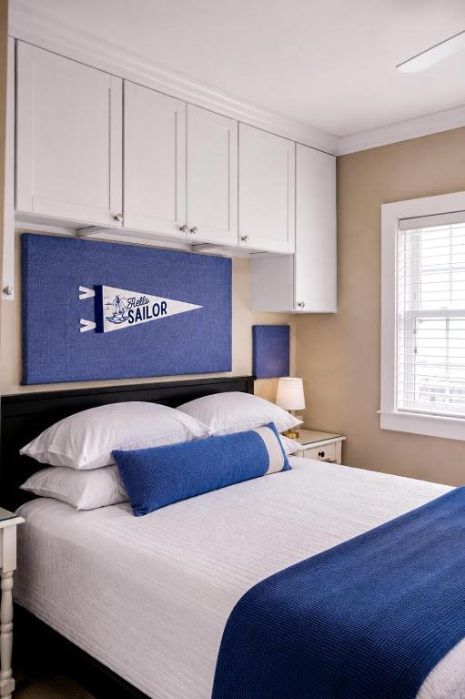 a bedroom with a large bed with white cabinets at Waterfront Studio - Bay Views, Steps to Comm St in Provincetown