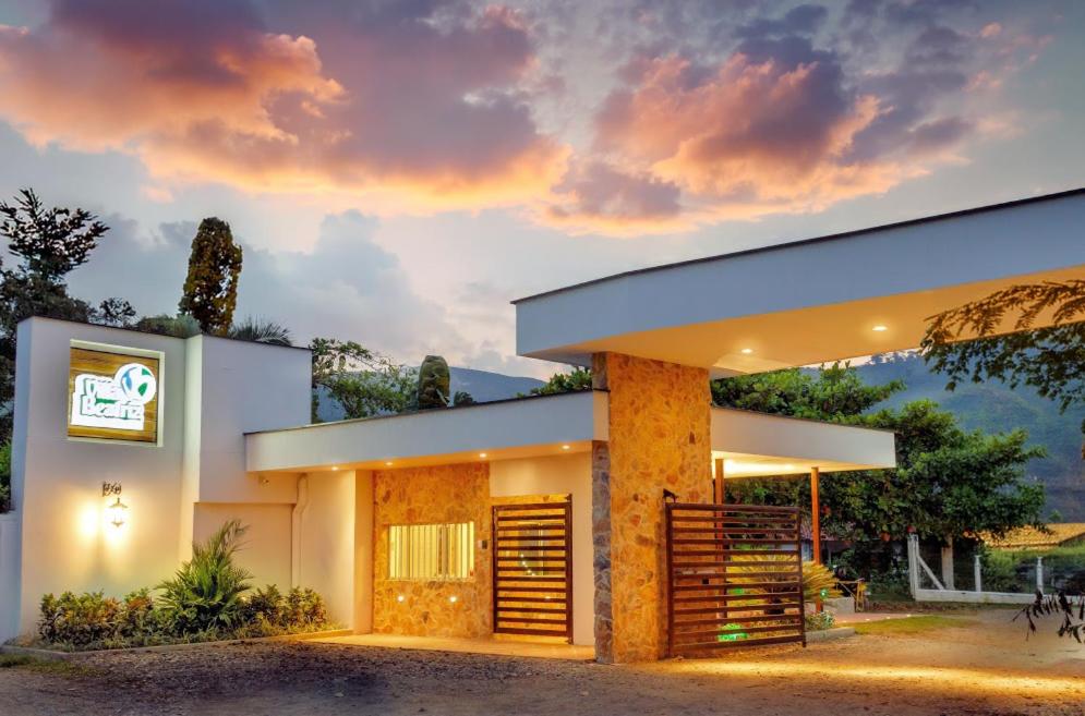 a house with a sunset in the background at Villa Beatriz in Palestina