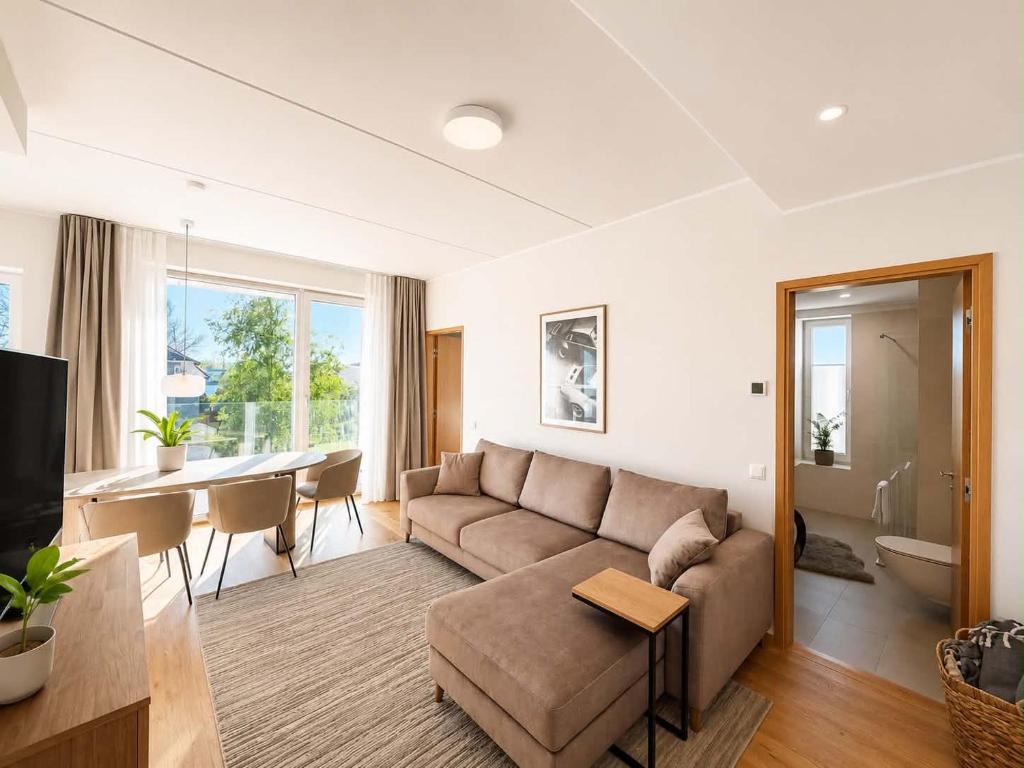 a living room with a couch and a table at Sadama Apartment in Haapsalu