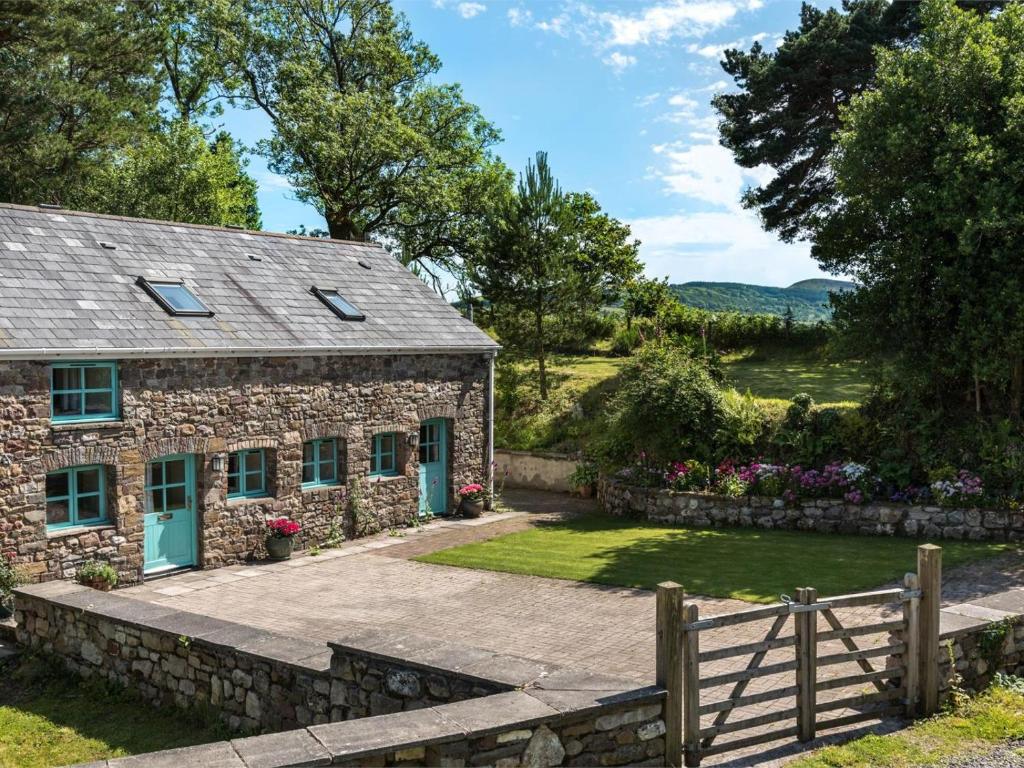 a stone cottage with a fence and a yard at 3 Bed in Swansea oc-bn172 in Ystalyfera