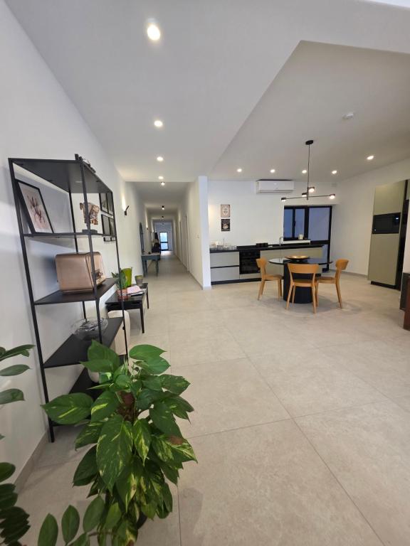 a large living room with a table and chairs at Luxury Waterfront 3BR Apartment with Large Terrace in Marsaskala