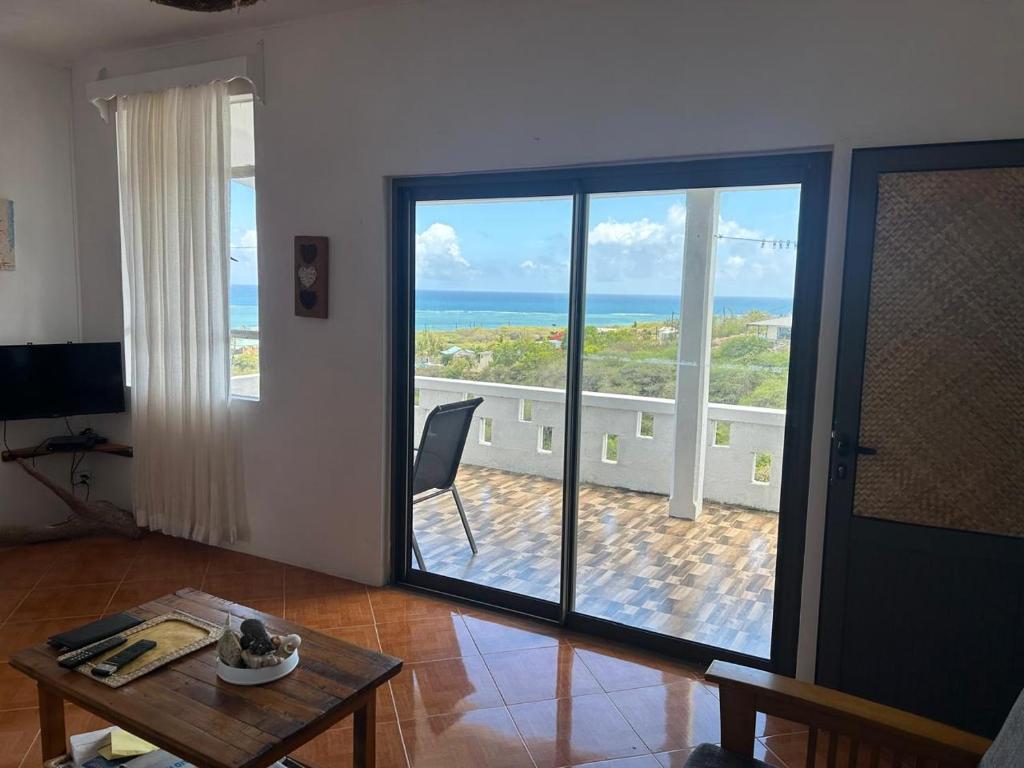 a living room with a view of the ocean at Eagle Nest Residence -Appartement 1 in Port Maturin