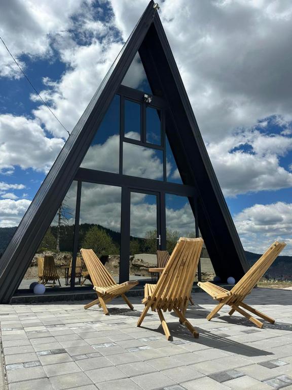 a group of chairs sitting in front of a large window at A Frame house Slavuljica in Vlasic
