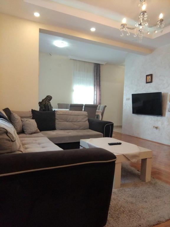 a living room with a couch and a table at Apartman Budva in Budva