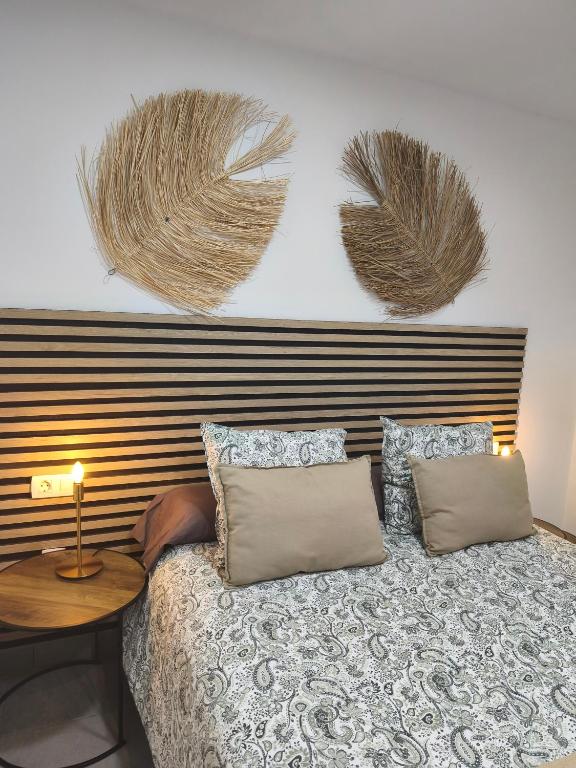 a bedroom with a bed with two pillows and a table at Central Apartment 4P Playa Chica Beach 2min WIFI in Puerto del Carmen