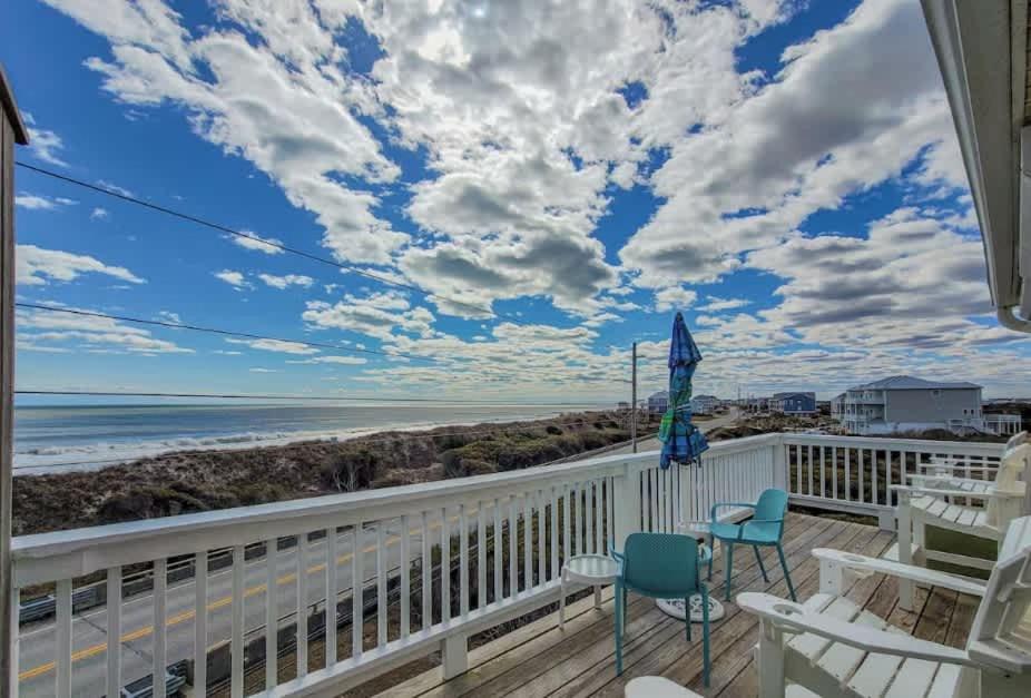 a balcony with chairs and a view of the beach at Oceanfront with Private Beach Access Sunset Views in Sneads Ferry
