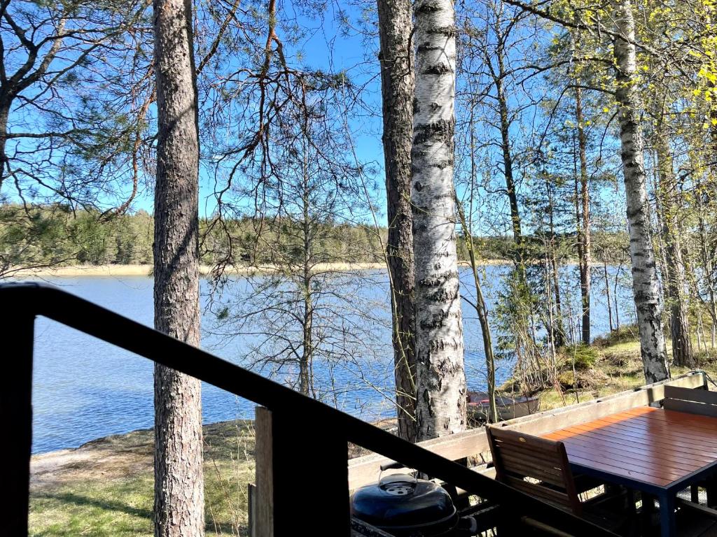 a view of a lake from the deck of a house at House in Beautiful Nature by the Sea Bay with Sauna & BBQ in Salpar