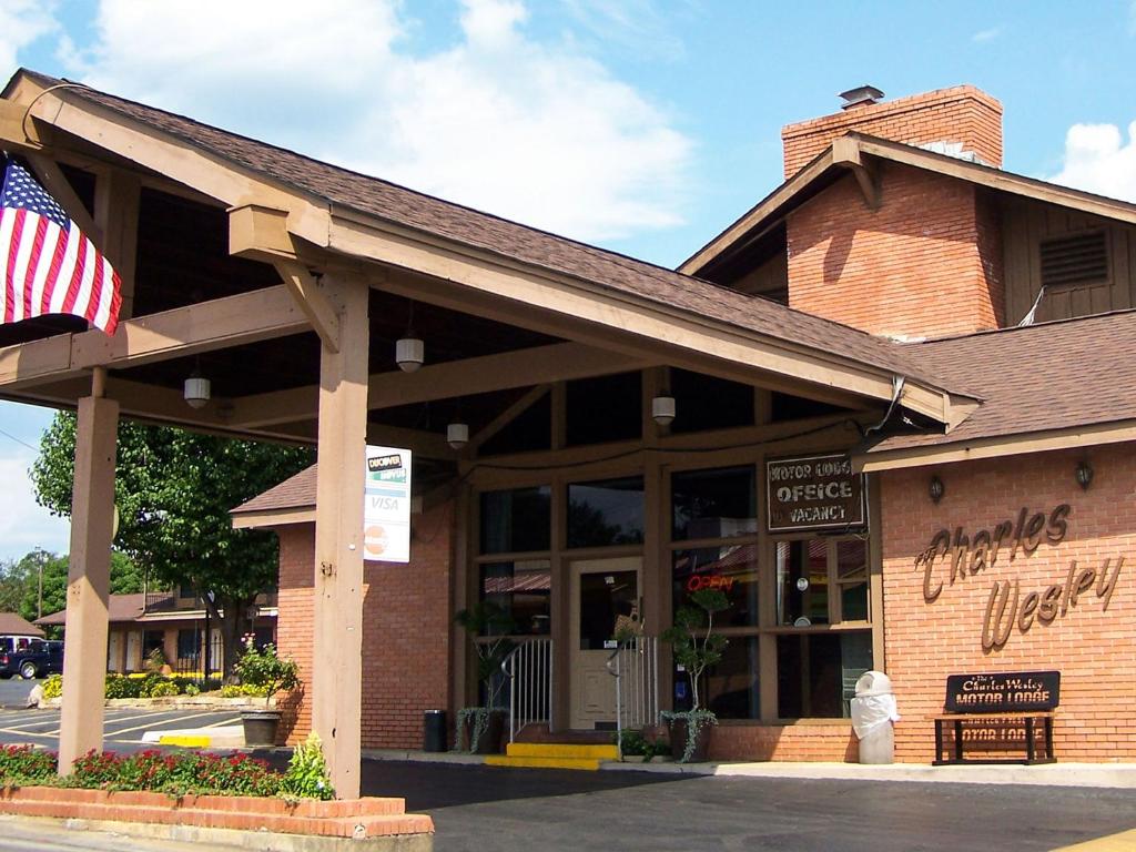 a store with an american flag in front of it at Charles Wesley Motor Lodge Downtown Broken Bow- Hochatown in Broken Bow