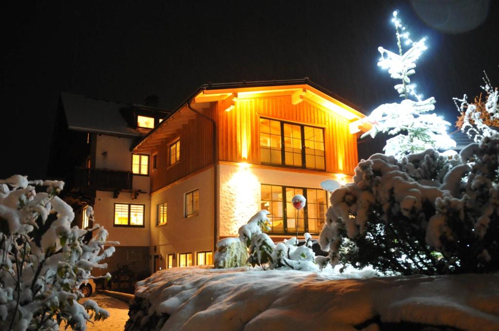 a building with a christmas tree in front of it at Romantikappartement Petz**** in Donnersbachwald