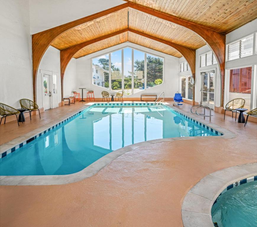 a large indoor pool with a wooden ceiling at Stargazer Hotel in Monterey