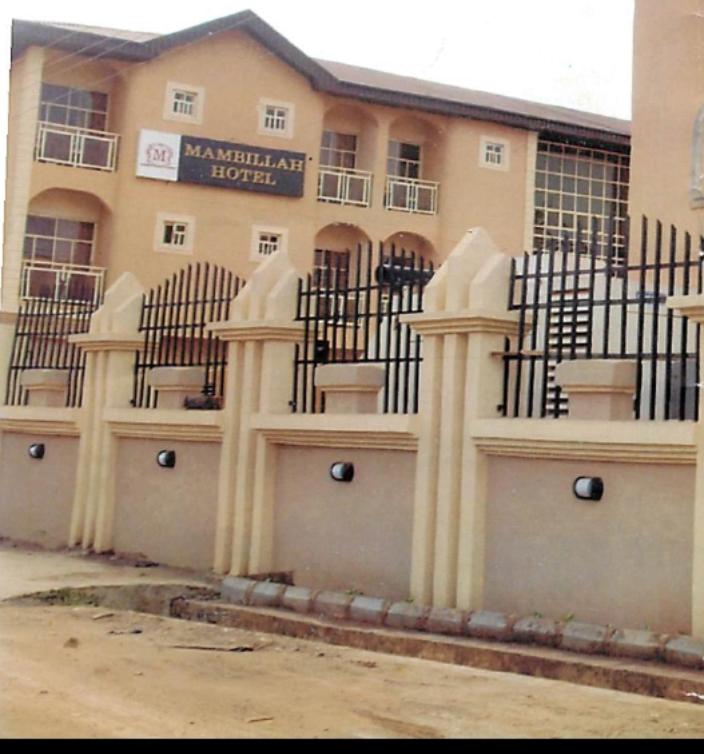 a building with a bunch of gates in front of it at Mambillah Hotel Ikorodu in Ikorodu
