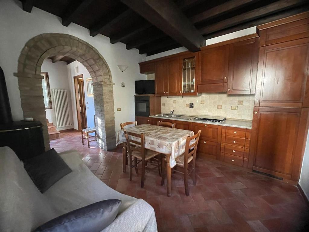 a kitchen with a table and chairs in a room at Casina Ghiana in Zocca