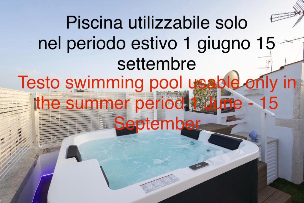 a bath tub in a bathroom with a soaking pool at Suite Arco Galera 63 in Putignano