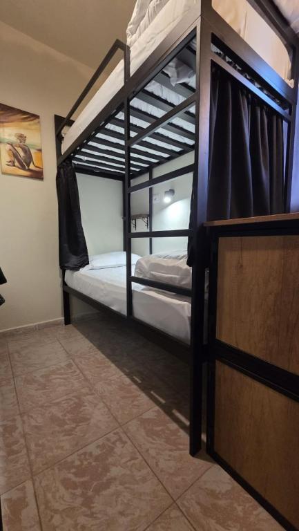 a bedroom with two bunk beds in a room at New Bazaar Hostel in Tirana