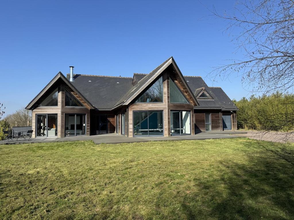 a large house with a gambrel roof at Harizou - Chalet & Piscine Intérieure in Saint-Pierre-la-Vieille