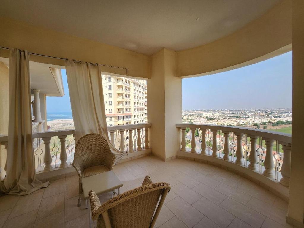 a room with a balcony with a view of the city at Royal Breeze Executive Studio in Ras al Khaimah