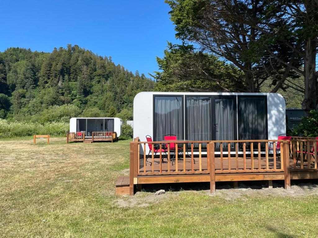 a couple of red chairs sitting in front of a trailer at Whistler - Apple Pod in Klamath