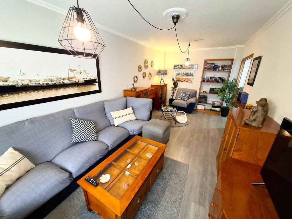 a living room with a couch and a coffee table at Dúplex 4 dormitorios Playa Foz in Foz
