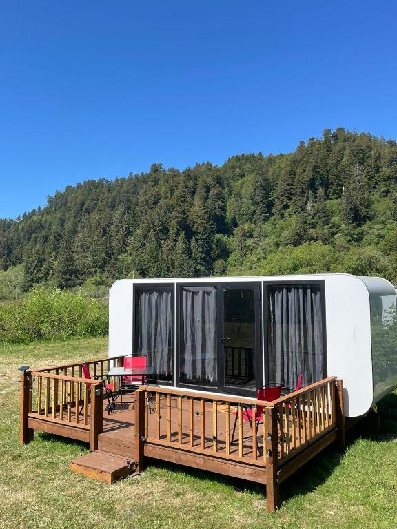 an rv parked on the grass next to a field at Blackcomb Apple Pod in Klamath