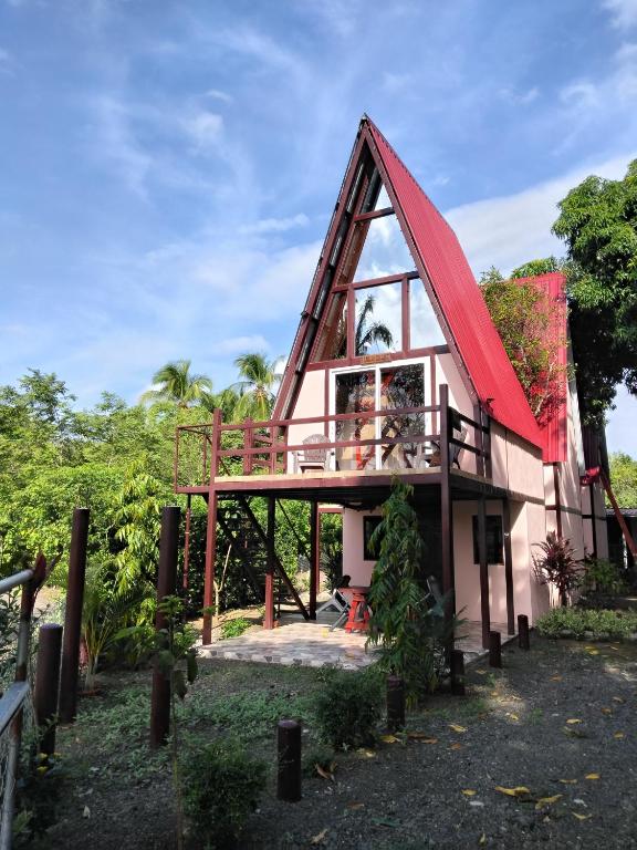 a small house with a red roof at Cabañas Martina Surf Playa Guanico in Pedregal