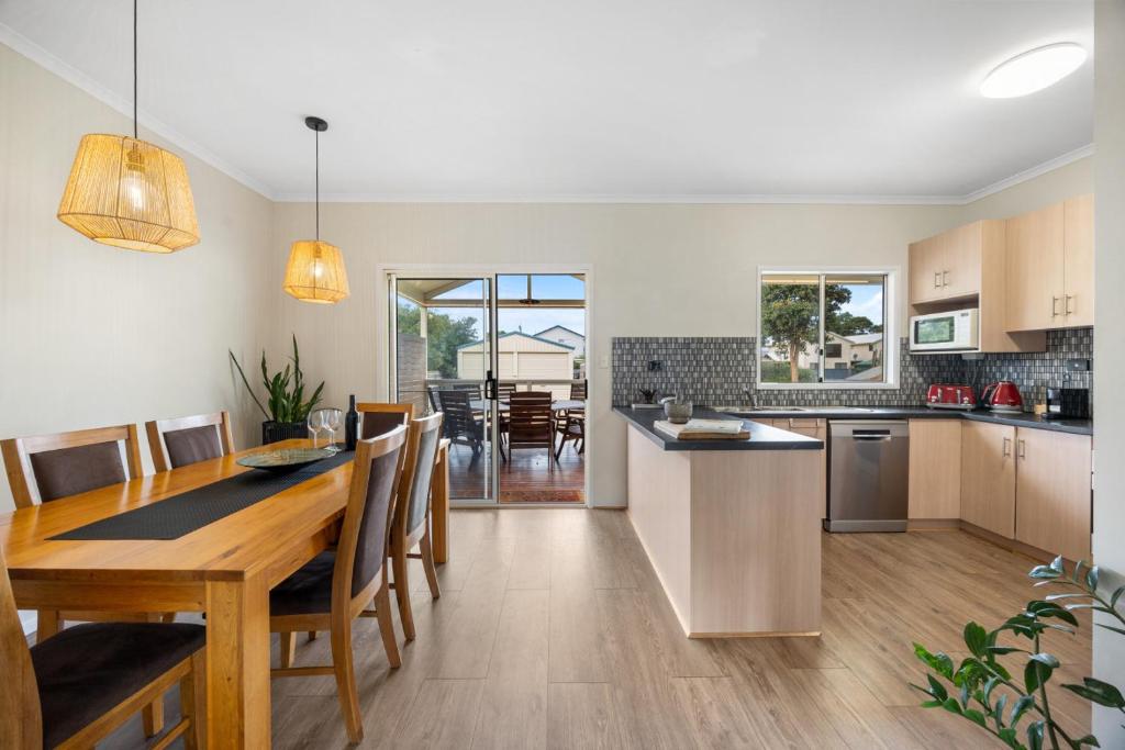 a kitchen and dining room with a table and chairs at Salt & Stay - Laid-Back Comfort by the Beach in Encounter Bay