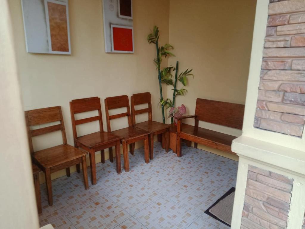 a waiting room with wooden benches and a plant at Ancestral BATO in Bato