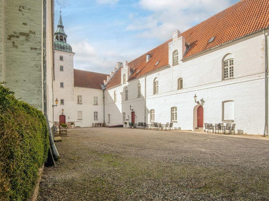 a large white building with a clock tower on top at Holiday home in Marstal in Brovst