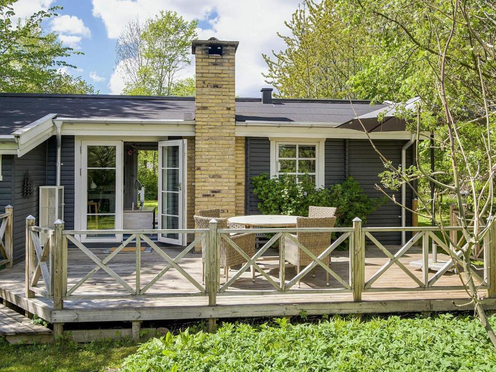a house with a wooden deck in front of it at 5 person holiday home in Vejby-By Traum in Vejby